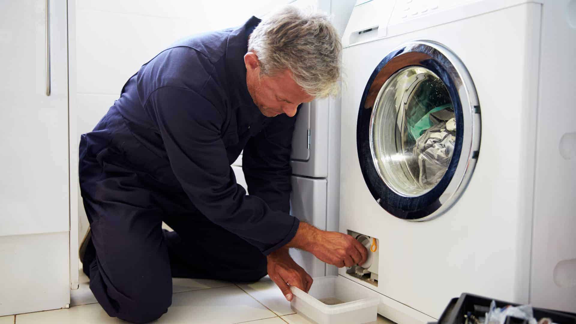 man in a jumpsuit repairing washing machine in Adelaide, fixing washing machine, washer Adelaide
