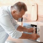 Man wondering why the microwave oven is not heating - what might be wrong
