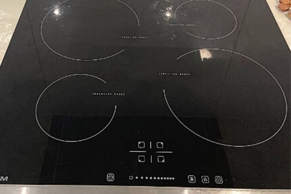 Black induction cooktop repaired by Quality Appliance Repairs Adelaide.