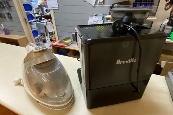 A coffee machine and a steam cleaner awaiting small appliance repairs in Melbourne