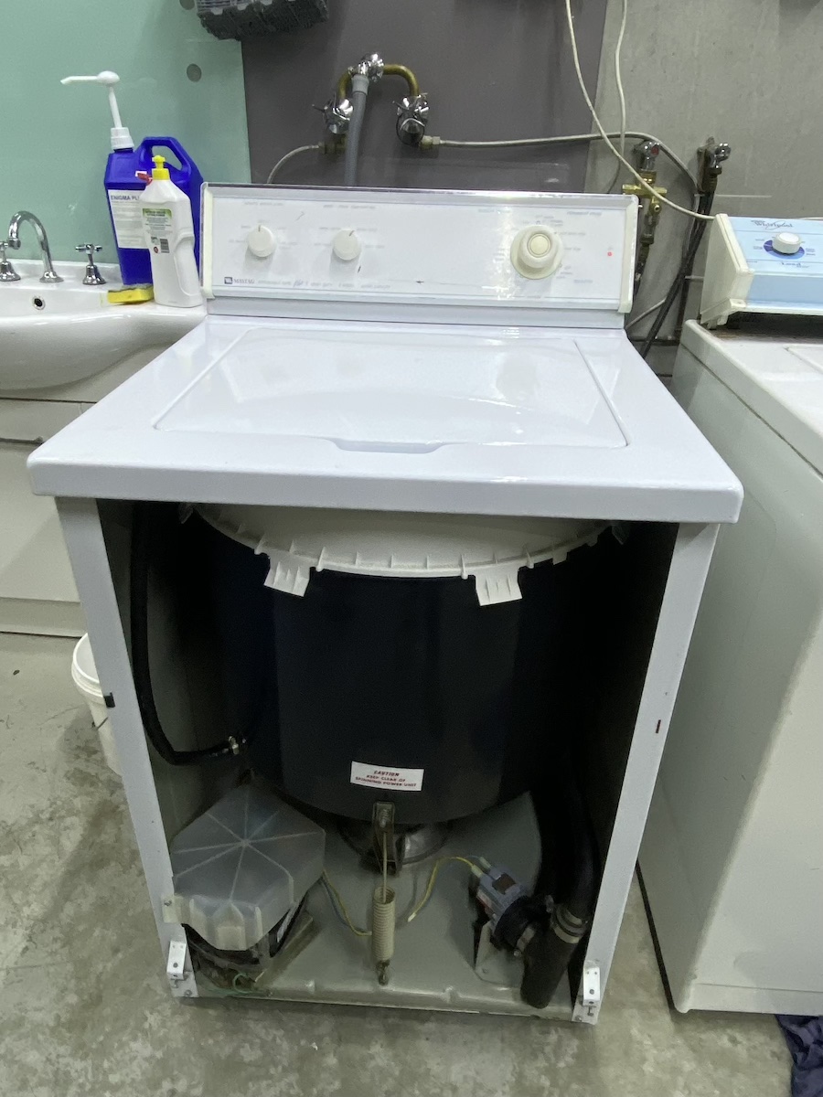top-load washing machine with its front panel removed